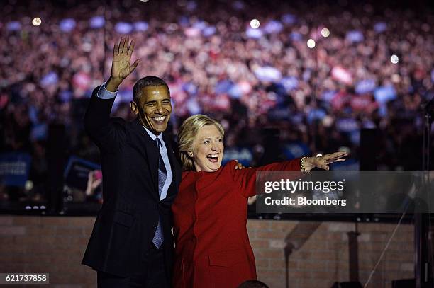 Hillary Clinton, 2016 Democratic presidential nominee, right, and U.S. President Barack Obama wave to the crowd during a campaign event in...