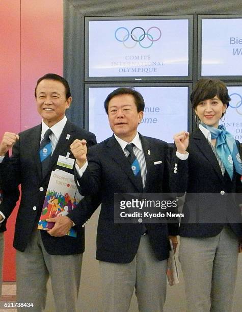 Switzerland - Japanese Deputy Prime Minister and Finance Minister Taro Aso, Tokyo Gov. Naoki Inose and newscaster Christel Takigawa pose for photos...