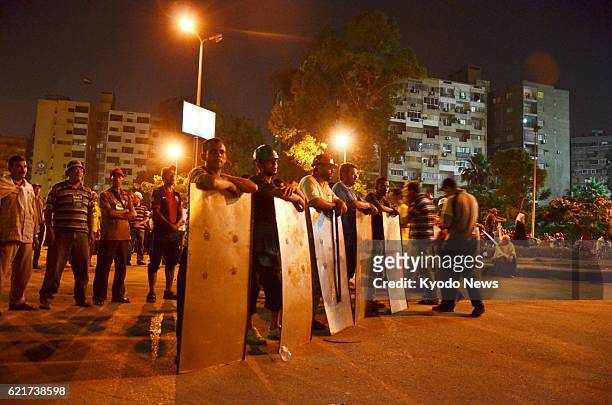 Egypt - A vigilante group formed by supporters of Egyptian President Mohammed Morsi gather in Nasser City near Cairo on the evening of July 3, 2013....