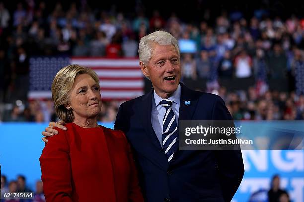 Democratic presidential nominee former Secretary of State Hillary Clinton and her husband former U.S. President Bill Clinton look on during a...