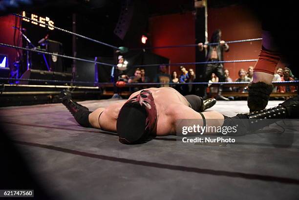 Wrestler lies on the floor at the match between &quot;El Craneo&quot; and &quot;Mat De Oyo&quot;during the Lucha Libre wrestling show in Toronto,...