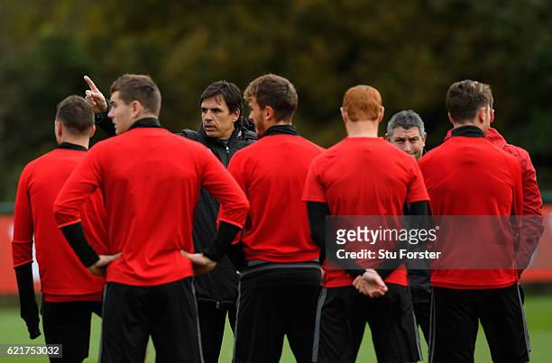 Wales coach Chris Coleman gives his players instructions ahead of their way to training ahead of their World Cup Qualifier against Serbia at the Vale...