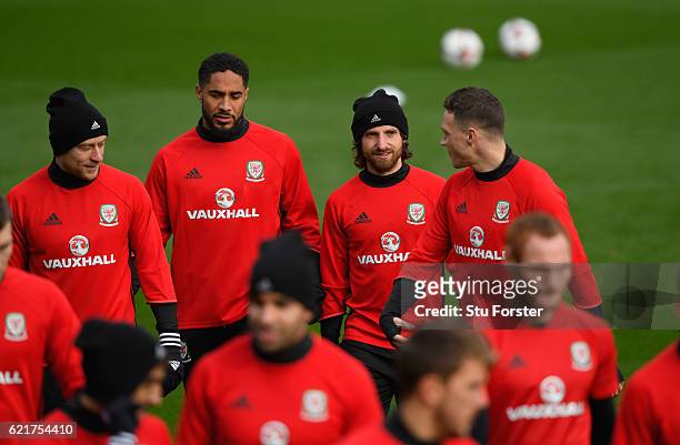 Wales captain Ashley Williams chats with Joe Allen James Chester and David Cotterill as the team make their way to training ahead of their World Cup...