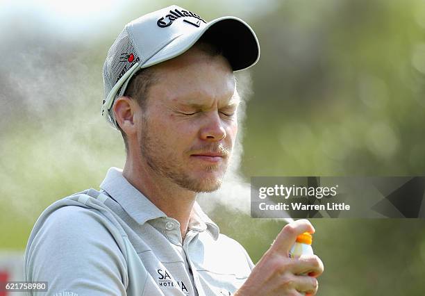 Danny Willett of England applies sun cream during a practice round ahead of the Nedbank Golf Challenge at the Gary Player CC on November 8, 2016 in...