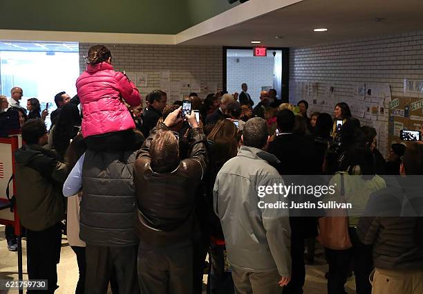 Crowd of people surround Democratic presidential nominee former Secretary of State Hillary Clinton as checks in to vote at Douglas Grafflin...