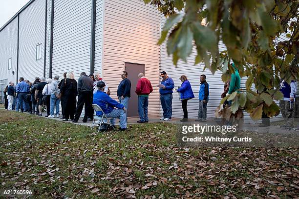 Voters wait in line to cast their ballots on November 8, 2016 Kansas City, Missouri. Americans will choose between Republican presidential candidate...