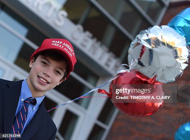 James Fiore wears his Donald Trump while accompanying his mother to cast her ballot for president at the Greenwich High School polling place in...