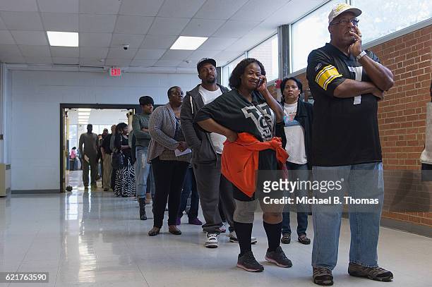 Voters wait in line to vote in the 2016 Presidential Election at Hazelwood Central High School on November 8, 2016 in Florissant, Missouri. Americans...