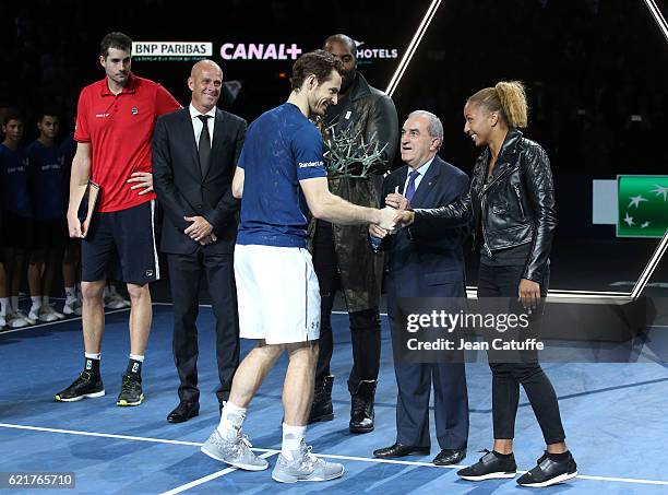 Winner Andy Murray of Great Britain is greeted by gold medalist in Rio Estelle Mossely while John Isner, Director of tournament Guy Forget, Teddy...