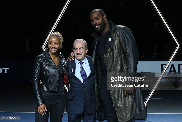President of French Tennis Federation Jean Gachassin poses between Teddy Riner and Estelle Mossely during the trophy presentation following the final...