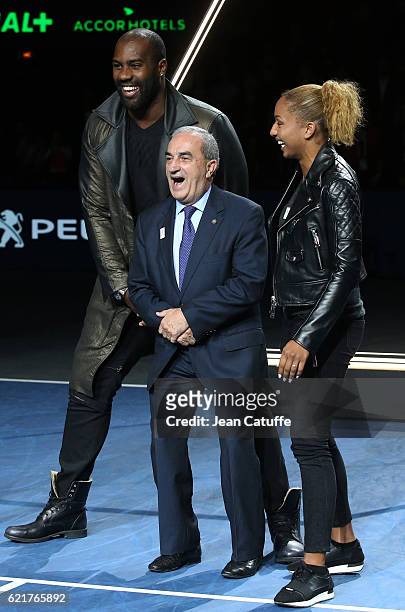 President of French Tennis Federation Jean Gachassin poses between Teddy Riner and Estelle Mossely during the trophy presentation following the final...