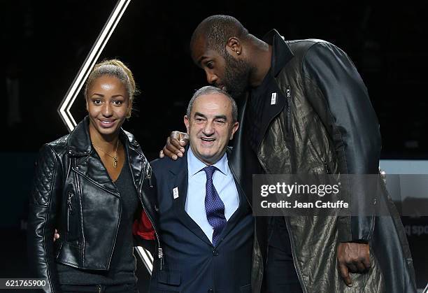 President of French Tennis Federation Jean Gachassin poses between Teddy Riner and Estelle Mossely during the trophy presentation following the final...