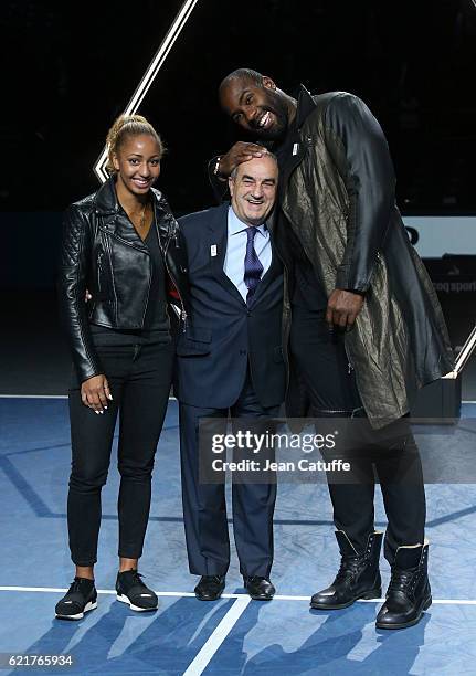 President of French Tennis Federation Jean Gachassin poses between Teddy Riner and Estelle Mossely during the trophy presentation following the final...