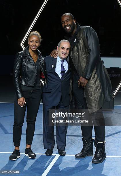 President of French Tennis Federation Jean Gachassin poses between Teddy Riner and Estelle Mossely during the trophy presentation following the final...