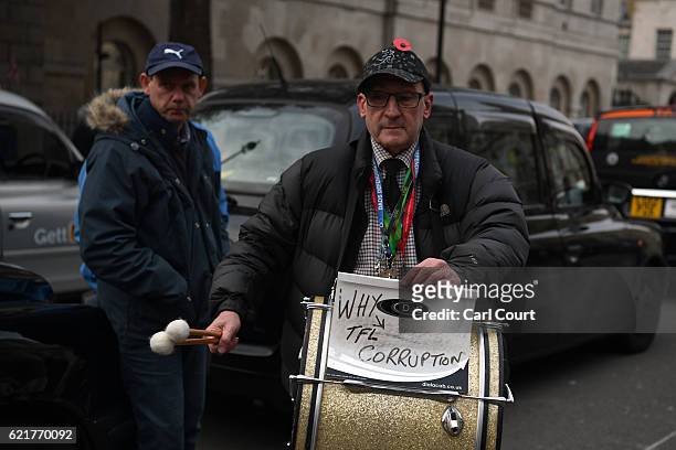 Black cab driver bangs a drum as he takes part in a protest to highlight congestion and air pollution on November 8, 2016 in London, England. Drivers...