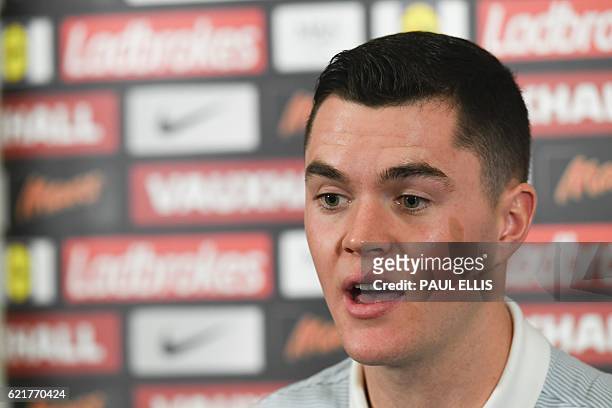 England defender Michael Keane speaks during a press conference at St George's Park in Burton-on-Trent on November 8 ahead of their group F World Cup...