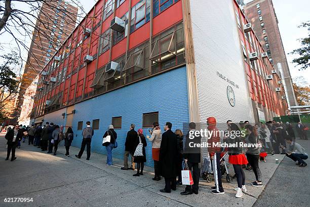 Lines of voters wrap around the outside of PS198M The Straus School as they wait to cast their ballots on November 8, 2016 in New York City, New...