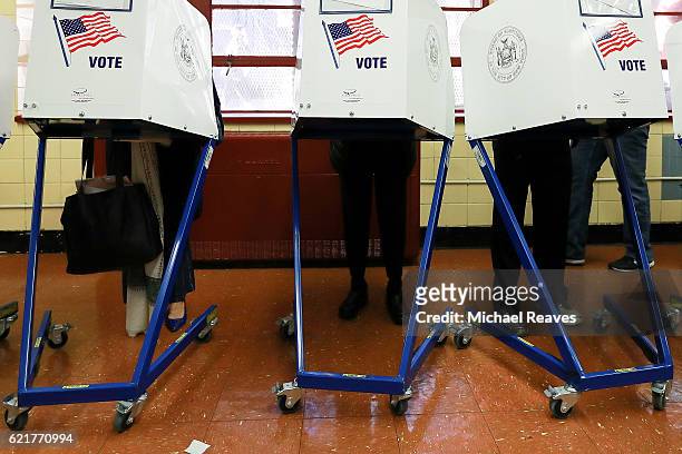 Voters cast their ballots at voting booths at PS198M The Straus School on November 8, 2016 in New York City, New York. Americans across the nation...