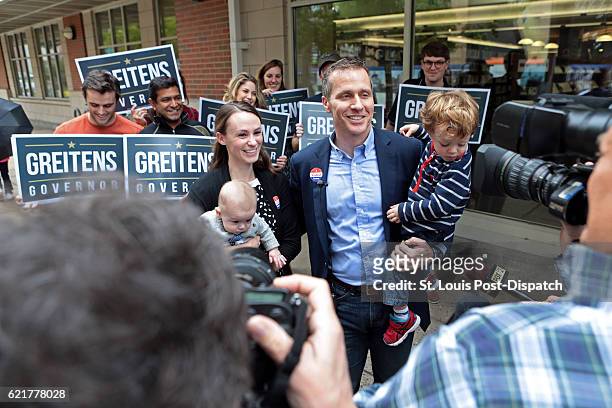 Republican gubernatorial candidate Eric Greitens and wife Sheena hold their children, Jacob and Joshua, while addressing the media after casting...