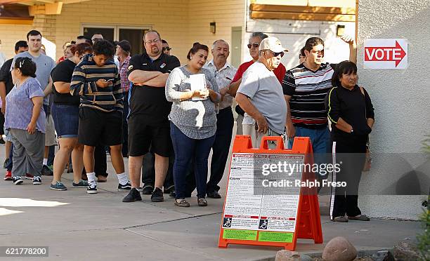 Voters wait in line at the Maryvale Church of the Nazarene polling place to cast their vote on November 8, 2016 in Phoenix, Arizona. Americans across...