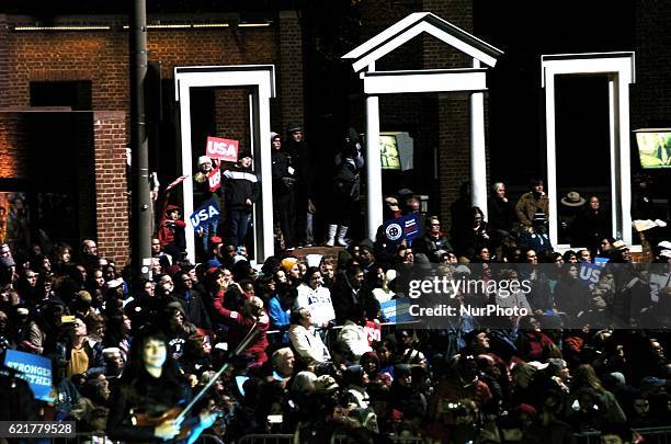 Youth from the packed crowds gathered to hear the Clinton Campaign's final pitch climb on a portion of a monument for a better view in Philadelphia...