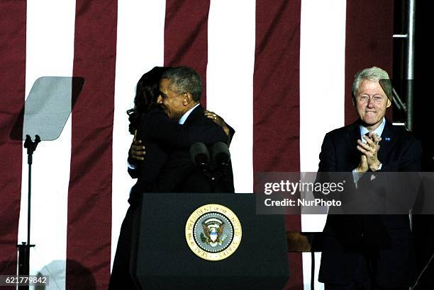 First Lady Michelle Obama embraces her husband President Barack Obama in Philadelphia on November 7, 2016.