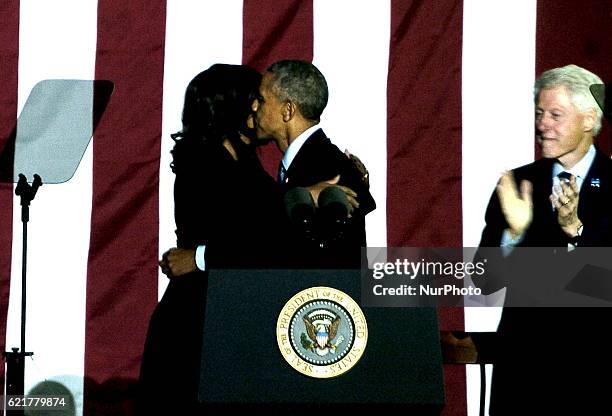 First Lady Michelle Obama embraces her husband President Barack Obama in Philadelphia on November 7, 2016.