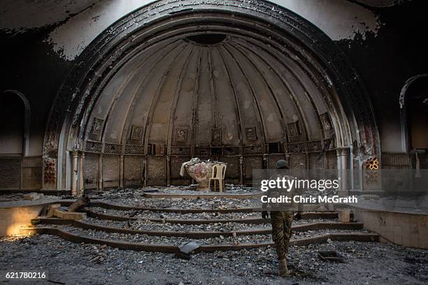 Fighter from the NPU waks through a destroyed church on November 8, 2016 in Qaraqosh, Iraq. The NPU is a military organization made up of Assyrian...