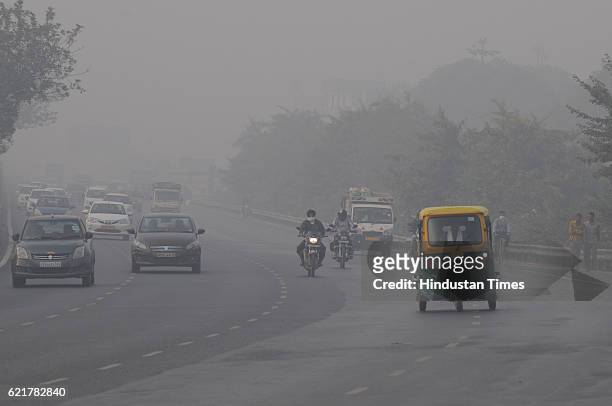 Traffic moving in smog in morning on November 8, 2016 in Gurgaon, India. After a week of smog filled air the city on Tuesday finally wakes up to a...