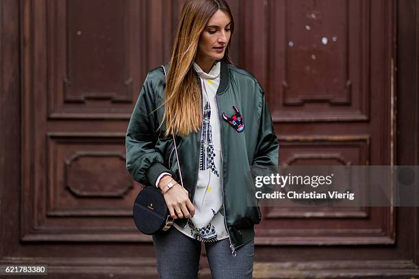 Fashion Blogger and Owner of SCIC Swimwear Sofia Grau wearing a white blouse Lala Berlin, a green jacket Zara, grey ruffled pants &otherstories,...