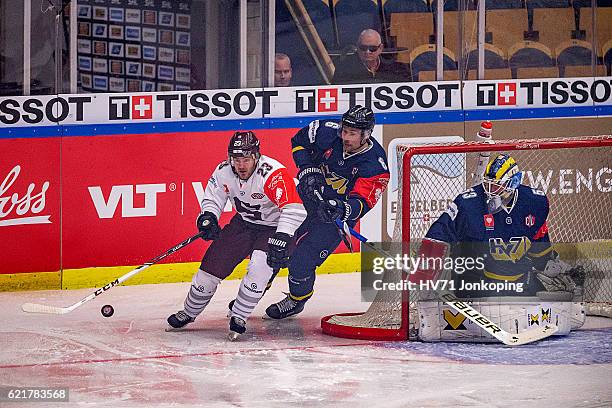 Lukas Pech of Sparta Prague passing behind Fredrik Pettersson-Wentzel goaltender of HV71 and chased by Cristoffer Persson of HV71 during the...