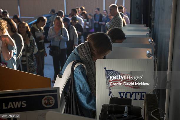 People vote at the Los Angeles Lifeguard station at Venice Beach on November 8, 2016 in Los Angeles, United States. In addition to choosing between...