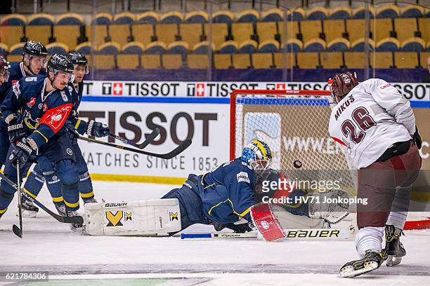Fredrik Pettersson-Wentzel goaltender of HV71trying to reach the shot from Juraj Mikus of Sparta Prague but has no luck so he scores during the...