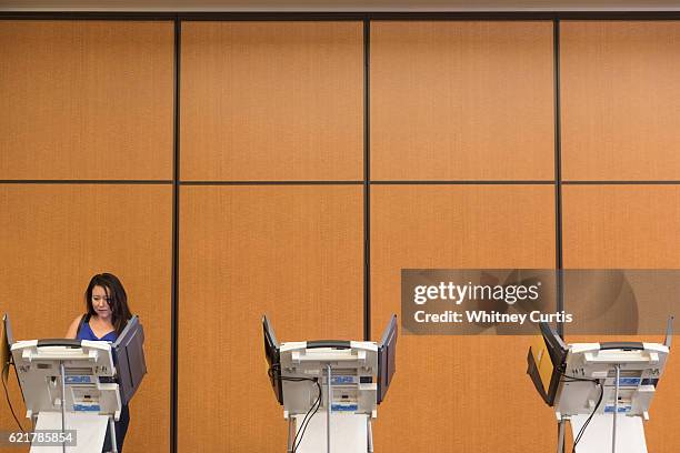 Shawna Vandevelde casts her electronic ballot on November 8, 2016 in Olathe, Kansas. After a contentious campaign season, Americans go to the polls...