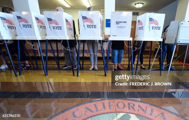 People vote on the US presidential election at Santa Monica City Hall on November 8, 2016 in Santa Monica, California. America's future hung in the...