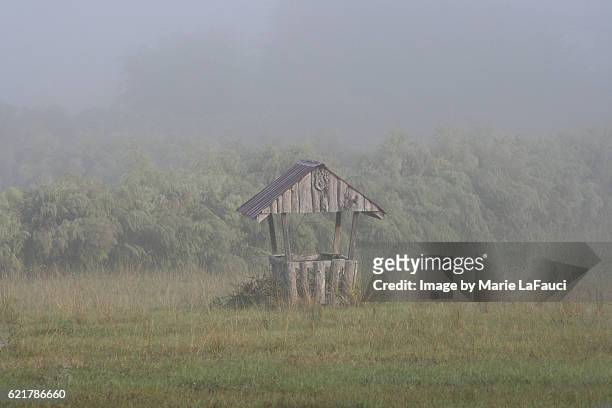 wooden wishing well with foggy pasture - sevenoaks stock pictures, royalty-free photos & images