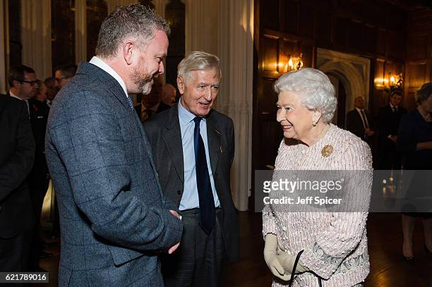 Artist Colin Davidson, Dr. Christopher Moran, Chairman Co-operation Ireland, and Queen Elizabeth II attend a Co-Operation Ireland Reception at Crosby...