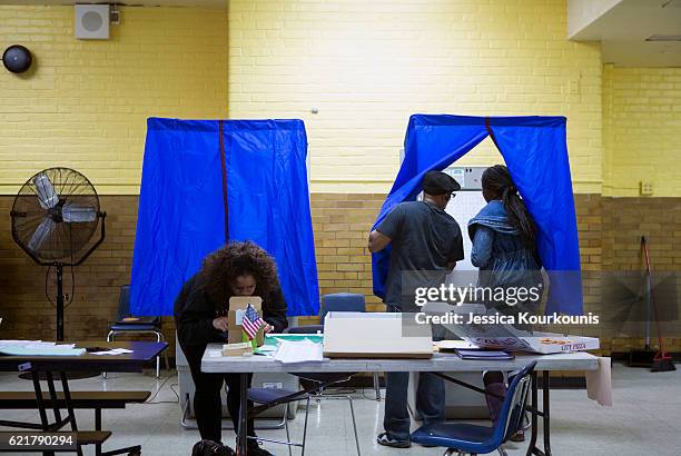 Woman enters a voting booth to cast her vote at Vare Edwin Middle School on November 8, 2016 in South Philadelphia, Pennsylvania. Americans across...