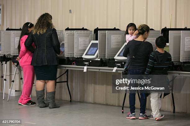 Phonexay Do casts her vote with her children, Ana and Tyler at the Gwinnett County Fairgrounds on November 8, 2016 in Lawrenceville, Georgia. After a...