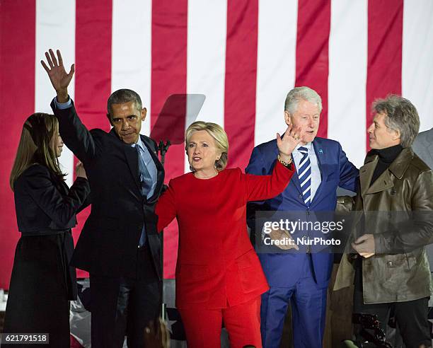 Presidential hopeful Hillary Clinton, walks the stage greeting the crowd with by her side , Chelsea Clinton, President Barack Obama, former President...