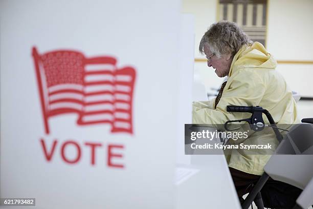 Bessy Jones, 101 years old, fills out her ballot at the Immaculate Conception Church on November 8 in Penacook, New Hampshire. Americans today will...