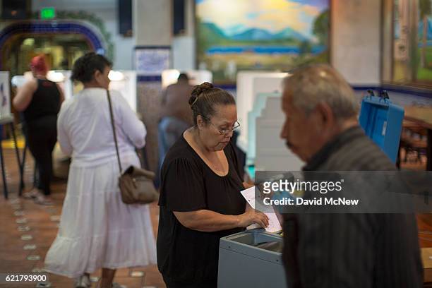 Latinos vote at a polling station in El Gallo Restaurant on November 8, 2016 in the Boyle Heights section of Los Angeles, California. In addition to...