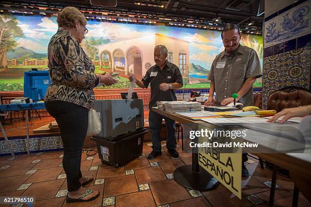 Latinos vote at a polling station in El Gallo Restaurant on November 8, 2016 in the Boyle Heights section of Los Angeles, California. In addition to...