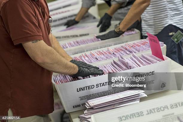 Officials sort mail-in-ballots in boxes at the San Francisco City Hall polling location in San Francisco, California, U.S., on Tuesday, Nov. 8, 2016....