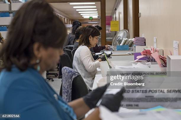 Officials sort mail-in-ballots at the San Francisco City Hall polling location in San Francisco, California, U.S., on Tuesday, Nov. 8, 2016. The...