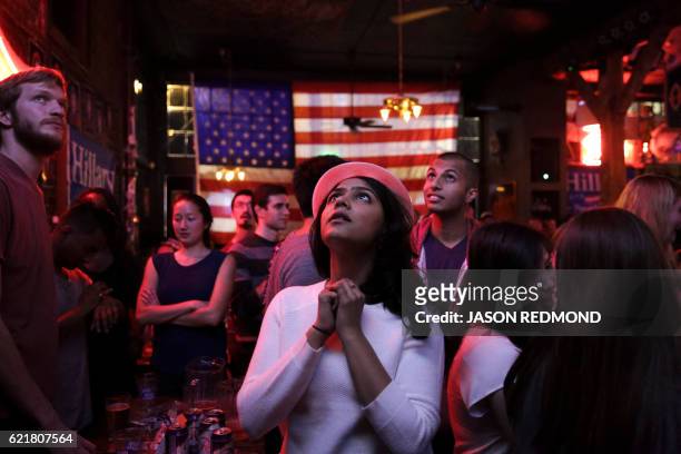 Sri Vasamsetti of Seattle and a supporter of Democratic presidential candidate Hillary Clinton, watches televised coverage of the US presidential...
