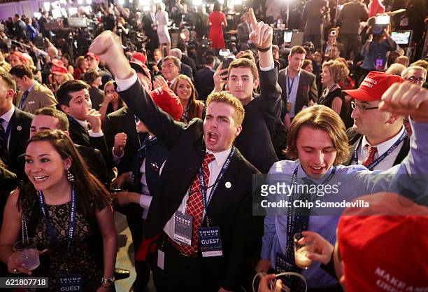 People cheer as voting results for Florida come in at Republican presidential nominee Donald Trumps election night event at the New York Hilton...