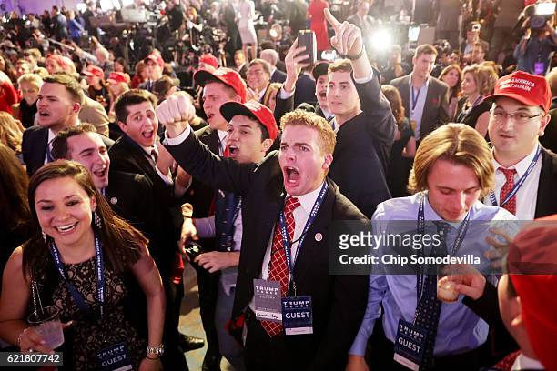People cheer as voting results for Florida come in at Republican presidential nominee Donald Trumps election night event at the New York Hilton...