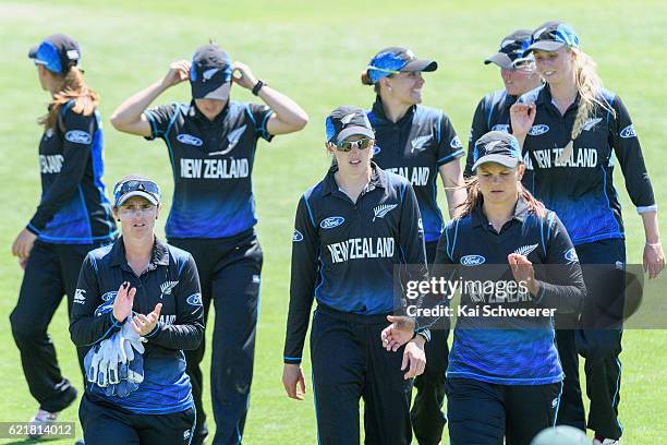 Katey Martin, Amy Satterthwaite and Suzie Bates of New Zealand walk from the ground at the lunch break during the Women's One Day International match...