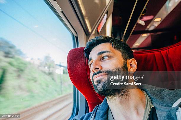 young man traveling in train - left eye stock pictures, royalty-free photos & images